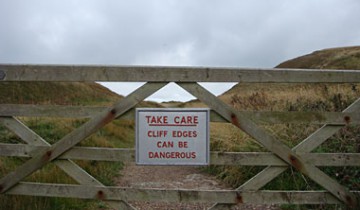 Sign reading that cliffs can be dangerous