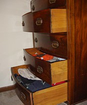An open bureau of drawers