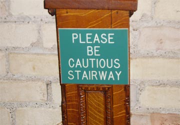 Sign reading 'Please be cautious stairway'