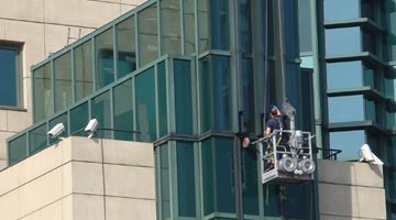 Man washing the windows at the headquarters of MI6
