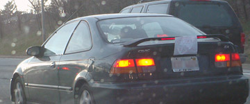 Car with student driver sign taped to the rear