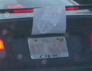 Car with student driver sign taped to the rear