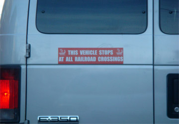Van door with railroad crossing notice