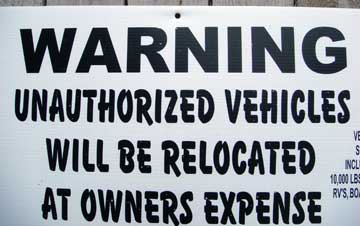 Unauthorized vehicles relocated at owner's expense