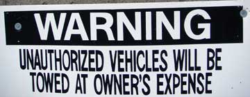 Unauthorized vehicles towed at owner's expense