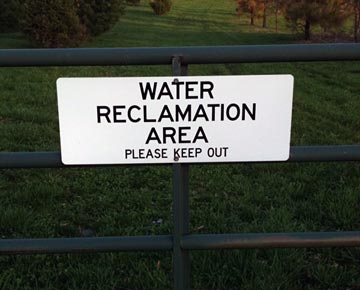 Sign on a gate that reads Water Reclamation Area, please keep out