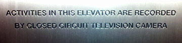 Elevator sign about being monitored on video