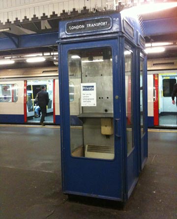 Old phone booth with private notice sign