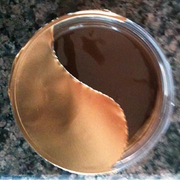 A jar of Nutella with the safety-seal torn off in the shape of yin-yang