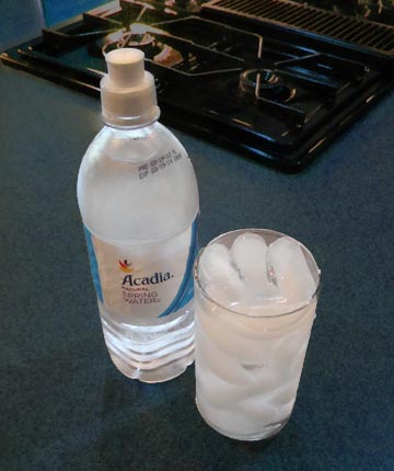 Ice water in a glass and bottle