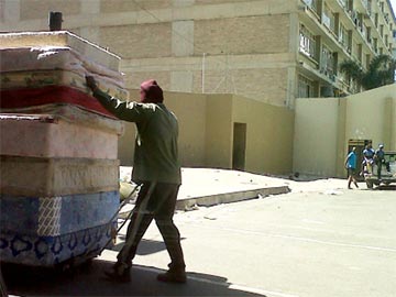 A guy pulling mattresses
