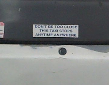 A sign in a taxi window