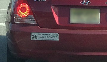 A bumper sticker that reads 'My other car is made of meat'