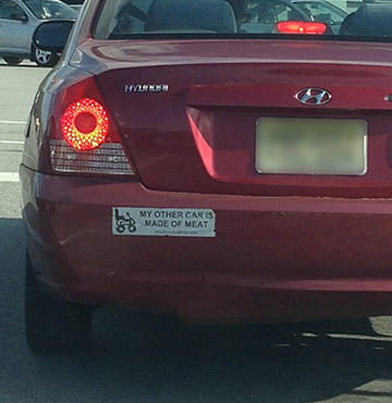 A bumper sticker that reads 'My other car is made of meat'