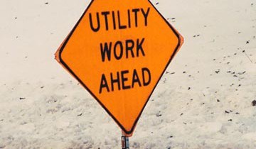 A sign reading "Utility Work Ahead"