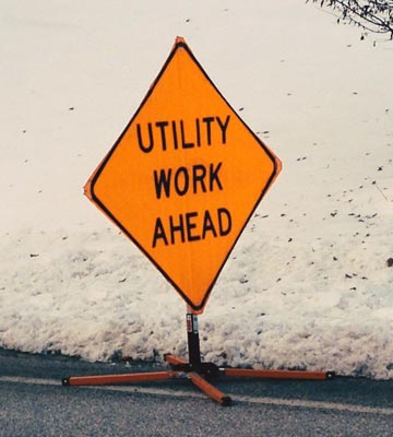A sign reading "Utility Work Ahead"