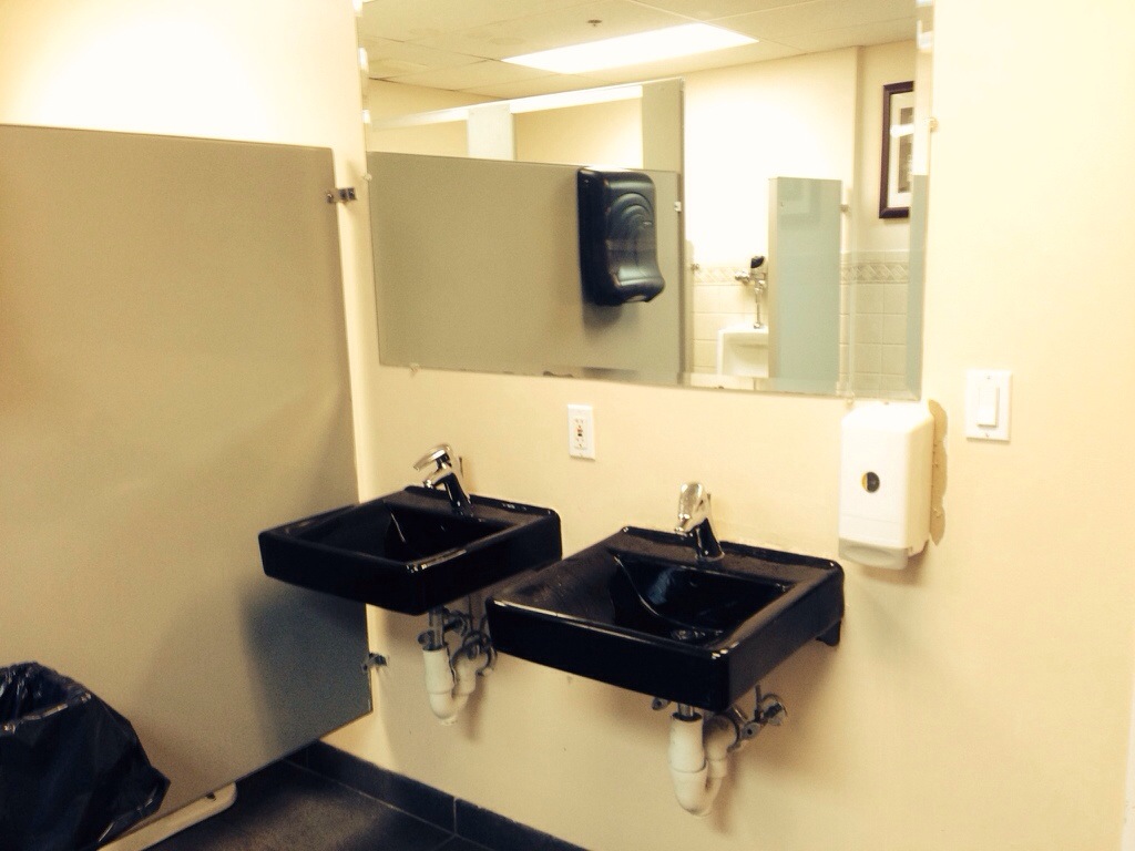 Men's restroom with oddly placed soap dispenser