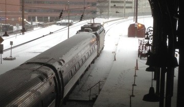 Snow falling outside a train platform
