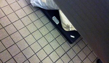 A laptop on a bathroom floor