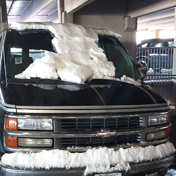 A van with snow on the windshield