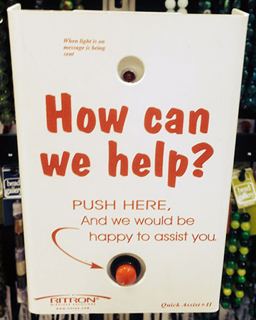 A "How can we help?" sign