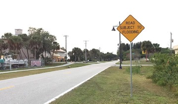 A sign reading "road subject to flooding"