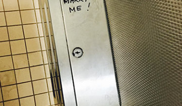 "Marry Me" scrawled in a toilet stall