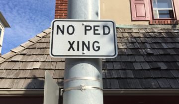 A sign reading 'No Ped Xing'