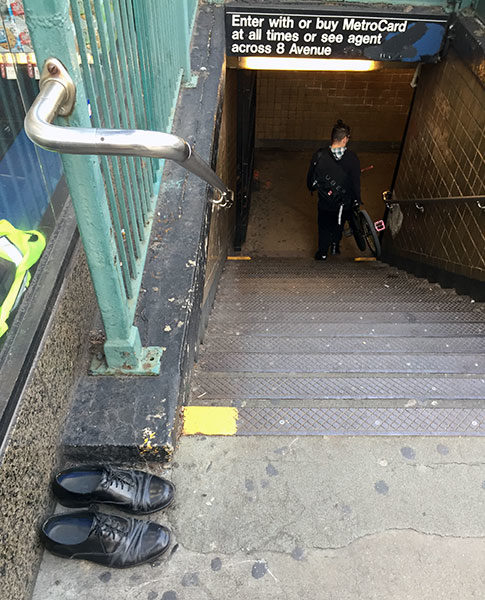 Dress shoes, neatly placed at the Subway entrace