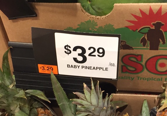 A store sign for baby pineapple