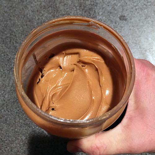 A jar of smooth peanut butter